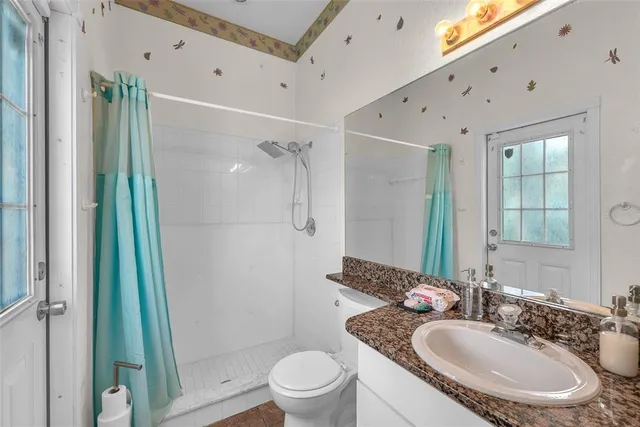 a bathroom with a toilet a sink and a mirror