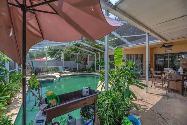 a view of a chair and table in patio with a garden