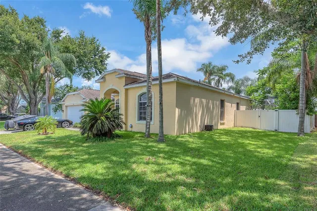 a front view of house with yard and trees