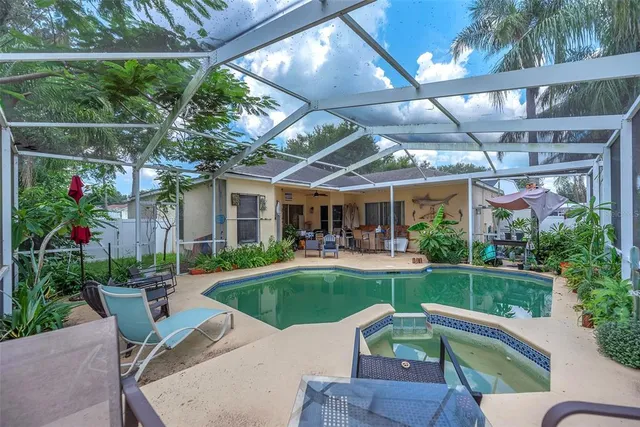 a view of a patio with couches table and chairs potted plants with wooden floor and fence