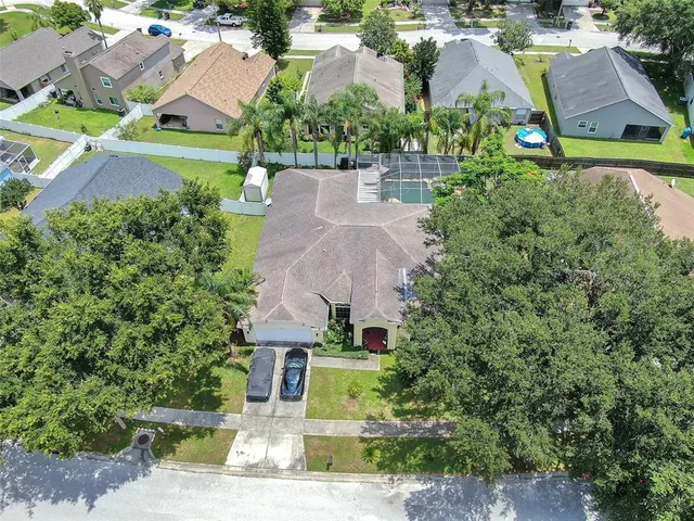 an aerial view of residential houses with outdoor space and street view