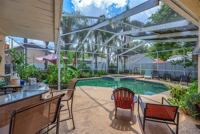 a backyard of a house with table and chairs