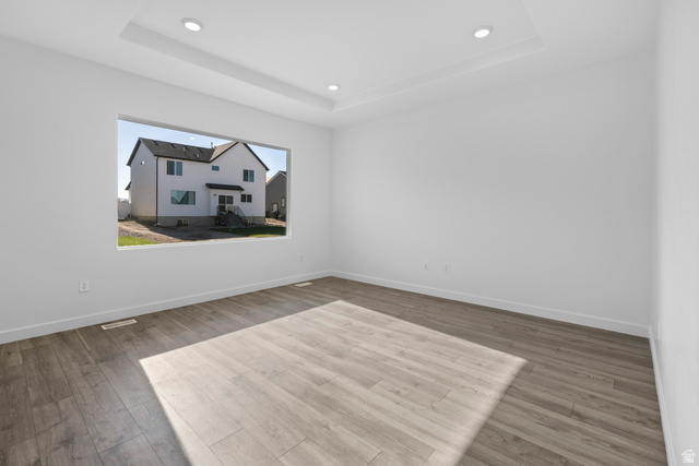 2823 North 710 West, Unit 16 Logan, UT 84321 - Photo 13 of 22 Empty room featuring light wood-type flooring, recessed lighting, and a raised ceiling