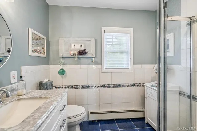 a bath room with a toilet a sink and a bath tub