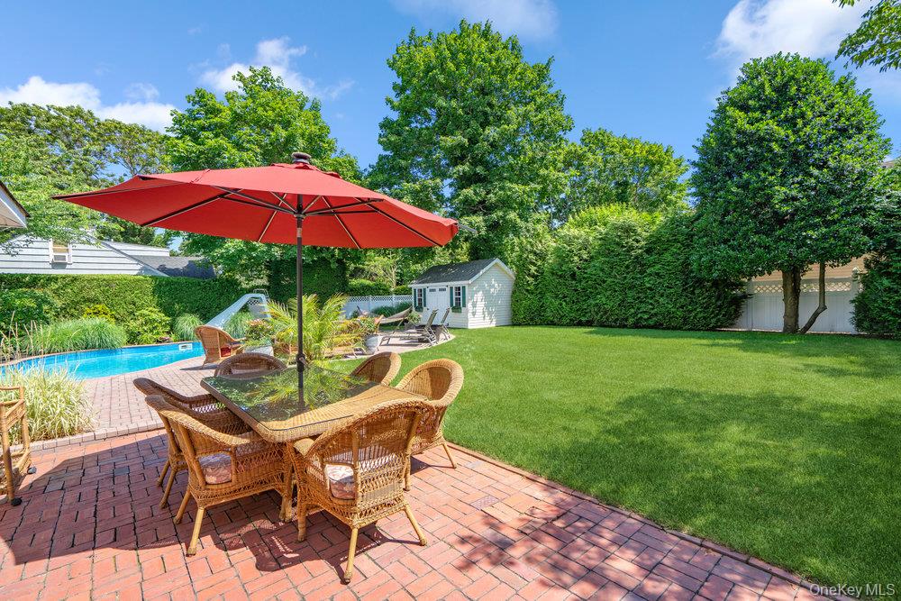1 Bayview Avenue Islip, NY 11751 - Photo 15 of 18 a patio with table and chairs under an umbrella