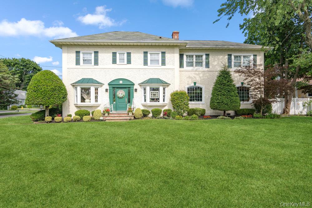 1 Bayview Avenue Islip, NY 11751 - Photo 2 of 18 a front view of a house with a garden