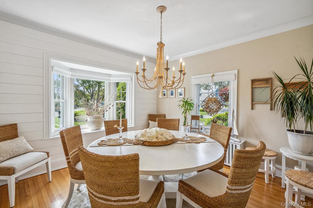 1 Bayview Avenue Islip, NY 11751 - Photo 4 of 18 a dining room with furniture a large window and wooden floor