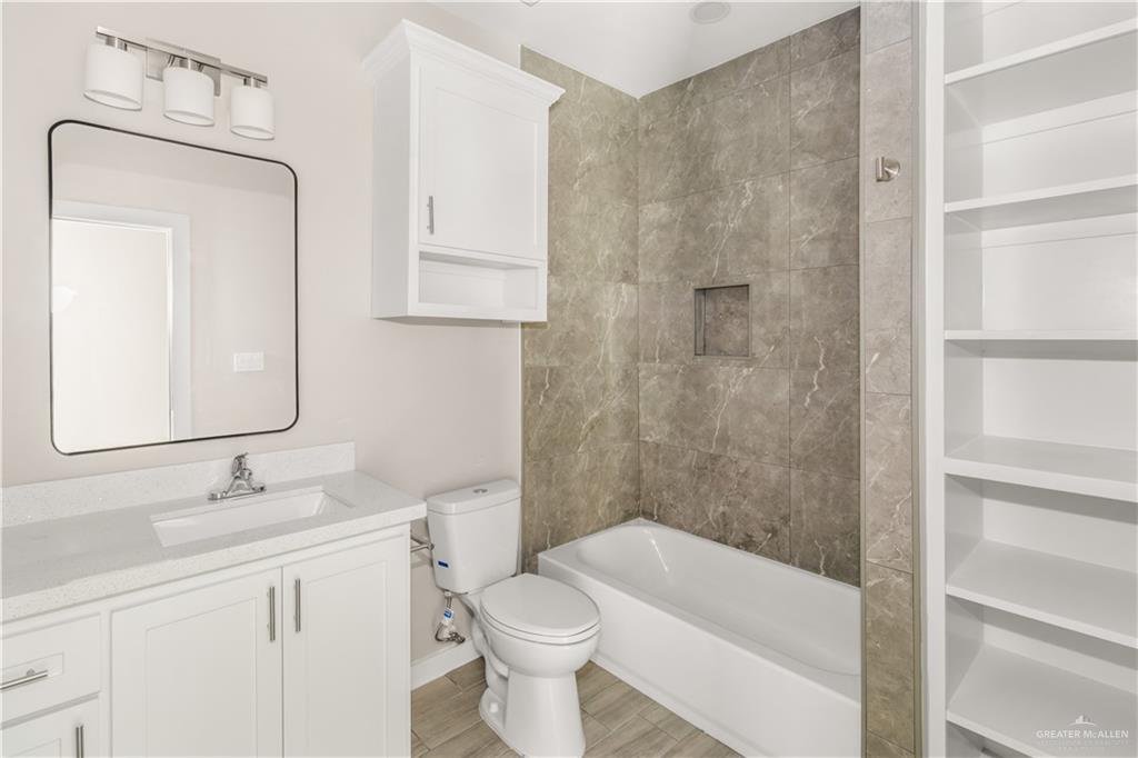 3186 Briggs Road, Unit 1 Weslaco, TX 78596 - Photo 12 of 13 a bathroom with a sink a toilet and shower