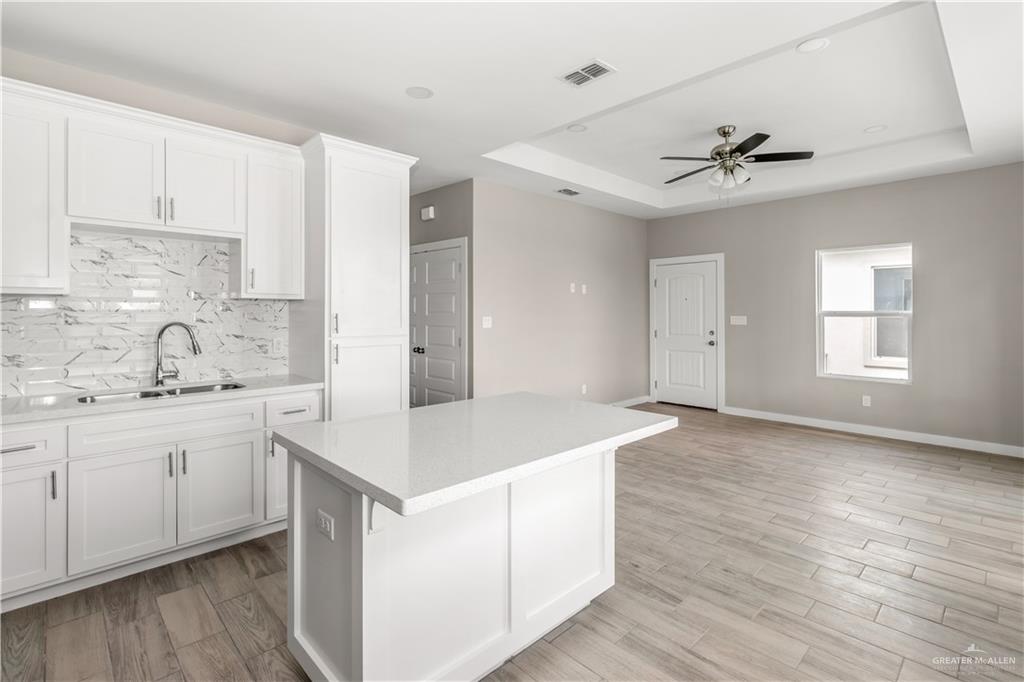 3186 Briggs Road, Unit 1 Weslaco, TX 78596 - Photo 5 of 13 a kitchen with a sink appliances and cabinets
