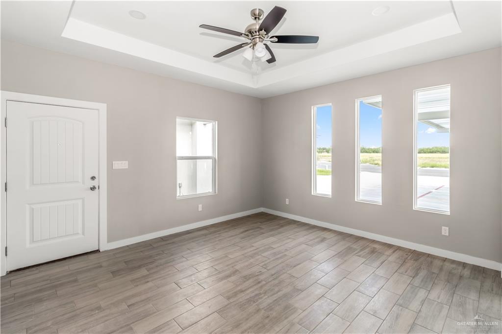3186 Briggs Road, Unit 1 Weslaco, TX 78596 - Photo 8 of 13 a view of a livingroom with a ceiling fan and window