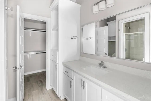 an empty room with a window and a ceiling fan