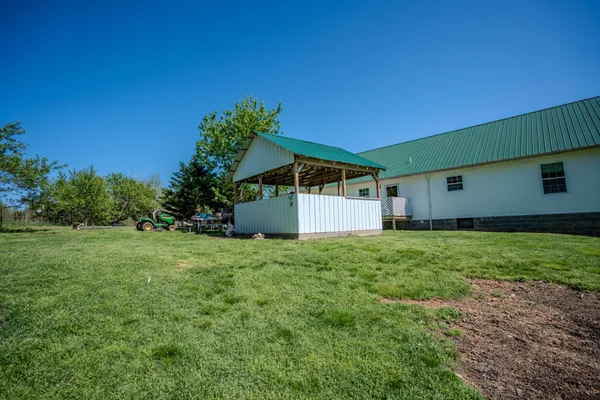 a house with green field in front of it