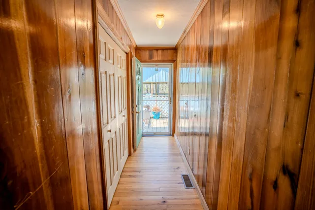 a view of a hallway with wooden floor