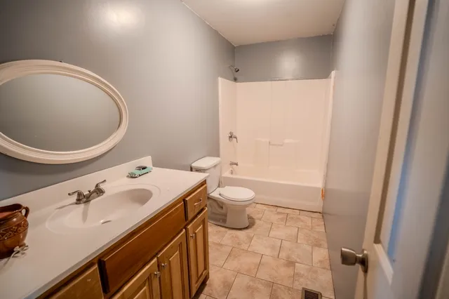 a bathroom with a sink a toilet and a mirror