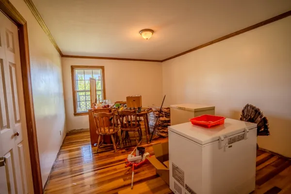 a dining room with furniture and wooden floor