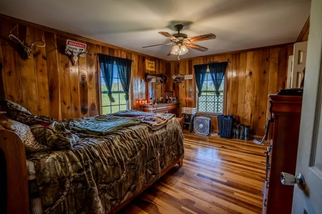 a bed sitting in a bedroom next to a window