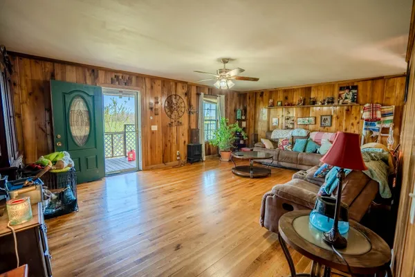 a living room with furniture and a wooden floor
