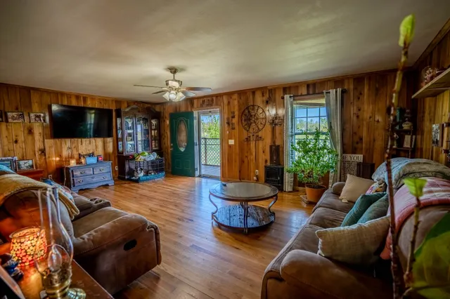 a living room with furniture a ceiling fan and a window