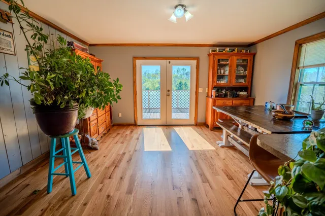 a very nice looking room with many windows and furniture