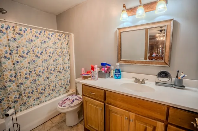 a bathroom with a sink toilet and a mirror