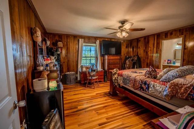 a bedroom with bed and glass door