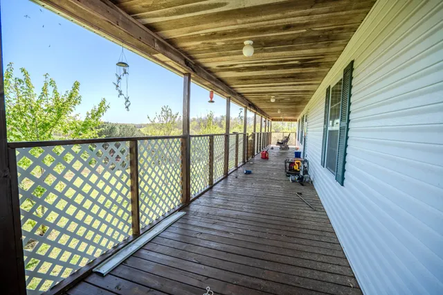 a view of a balcony with wooden floor