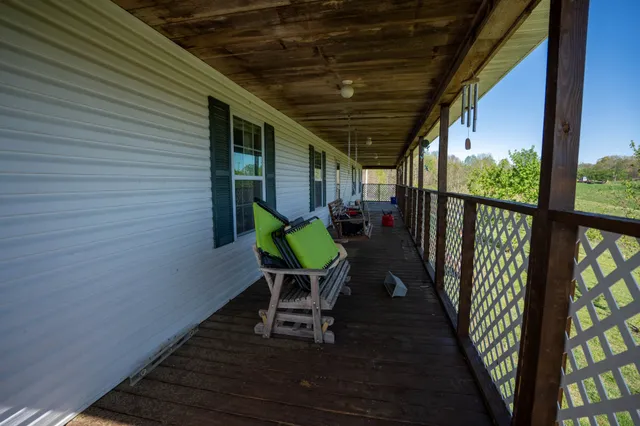 a chair and table in wooden deck