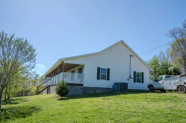 a house view with a sitting space and garden