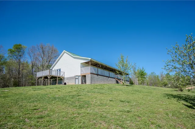 a house with green field in front of it