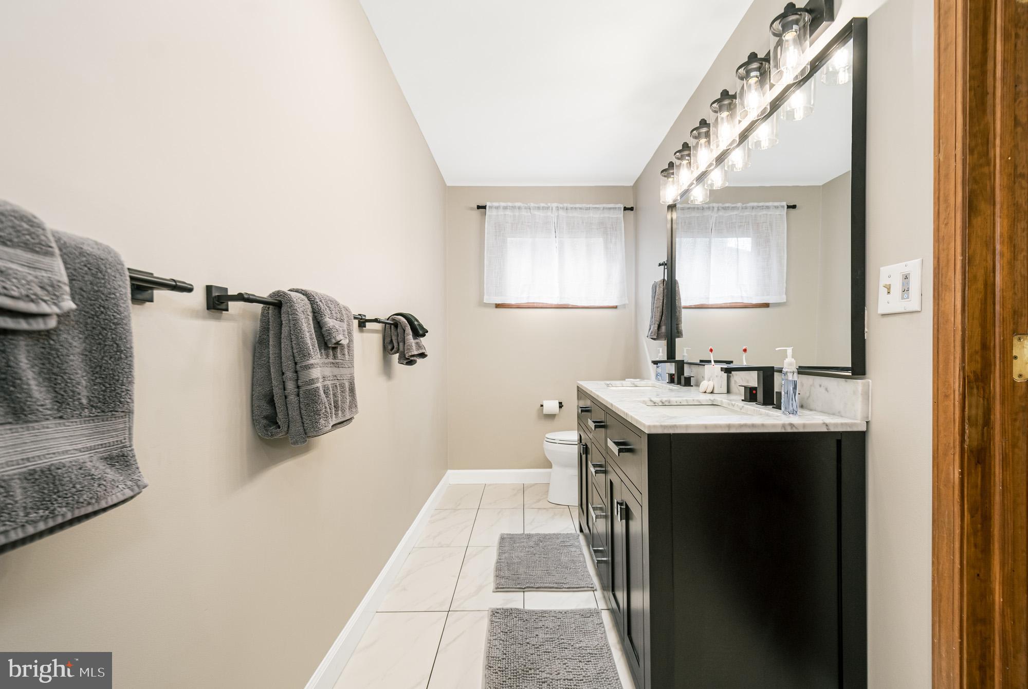390 Glen Cove Road Swanton, MD 21561 - Photo 32 of 73 a bathroom with a sink and mirror