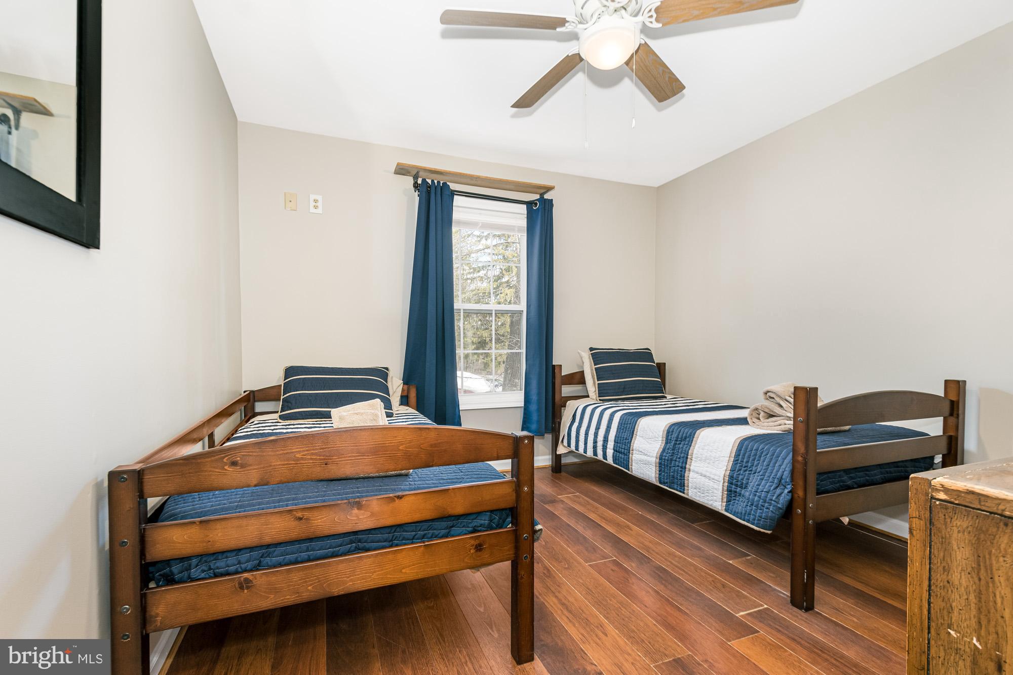 390 Glen Cove Road Swanton, MD 21561 - Photo 52 of 73 a bedroom with a bed and wooden floor