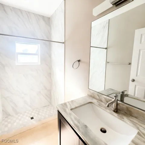 a bathroom with a sink and a mirror