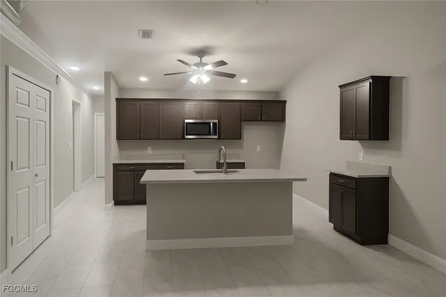 a view of living room kitchen with stainless steel appliances granite countertop stove top oven and cabinets