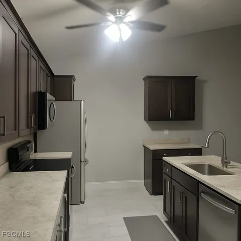 a kitchen with a sink and a refrigerator