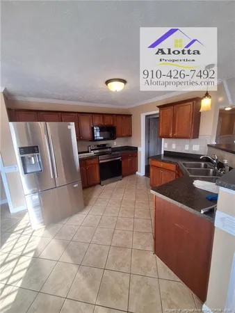 a kitchen with stainless steel appliances granite countertop a sink and a stove top oven