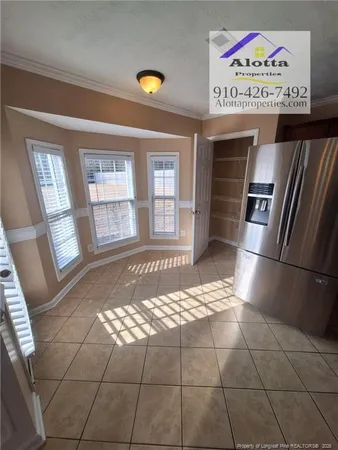 a kitchen with a stove a refrigerator and a window