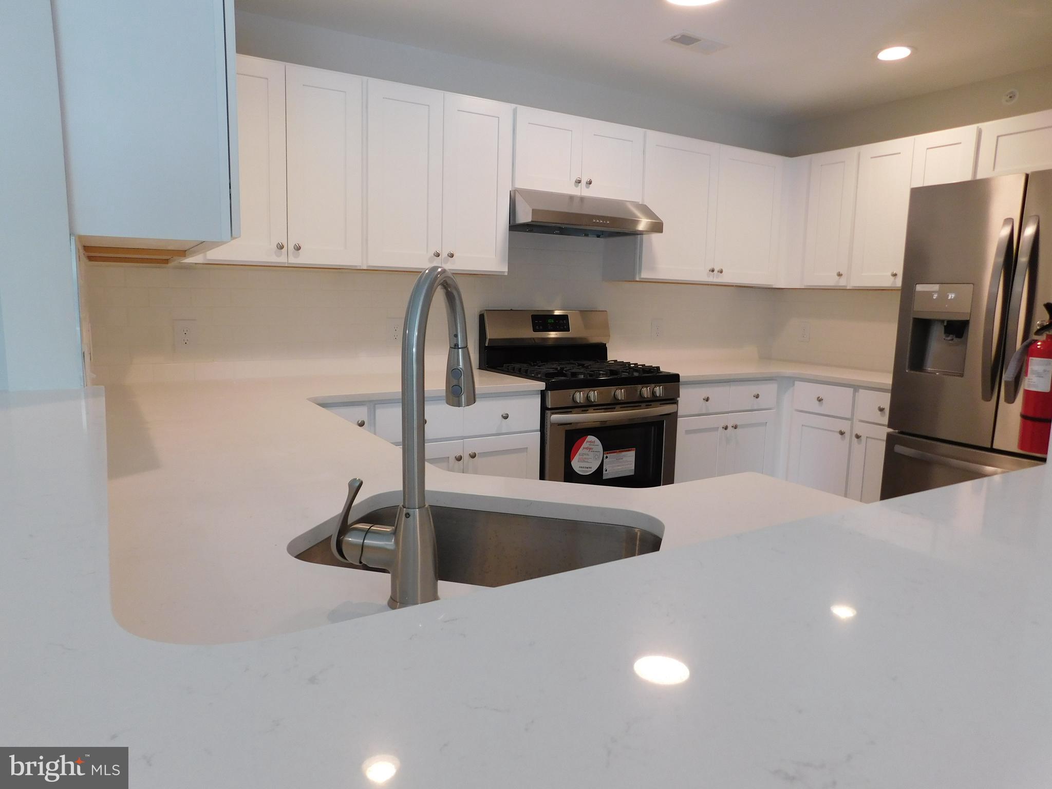 165 Natalie Road Delran, NJ 08075 - Photo 9 of 16 a kitchen with stainless steel appliances a sink a stove a refrigerator and cabinets