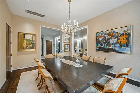 a view of a dining room with furniture and chandelier