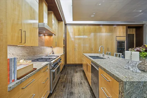 a kitchen with stainless steel appliances granite countertop a stove and a sink