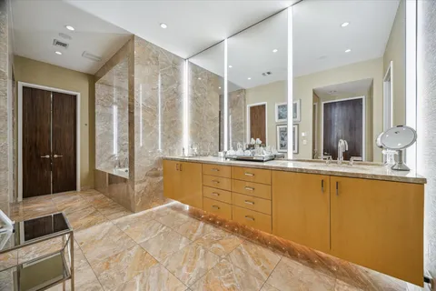 a spacious bathroom with a mirror sink and vanity