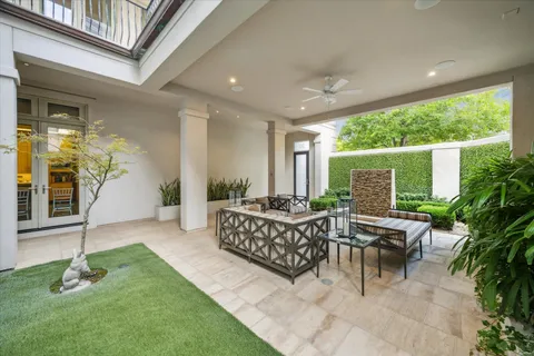 a view of a patio with couches table and chairs and potted plants