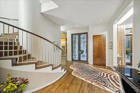 a view of a bedroom with wooden floor and windows
