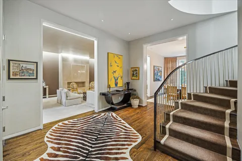 a bedroom with furniture and a wooden floor