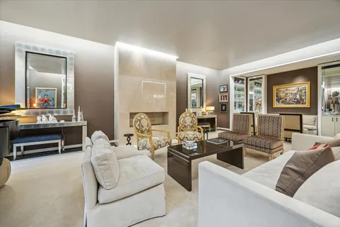 a living room with furniture and large windows