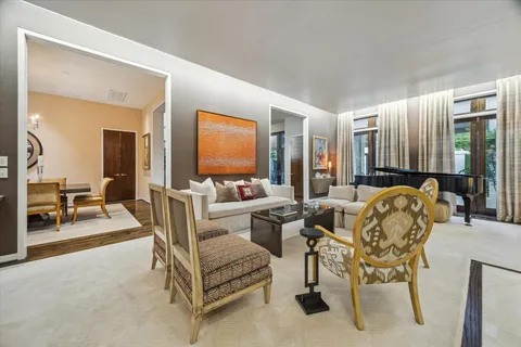 a living room with furniture and a large mirror