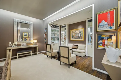 a living room with furniture a rug and a large window