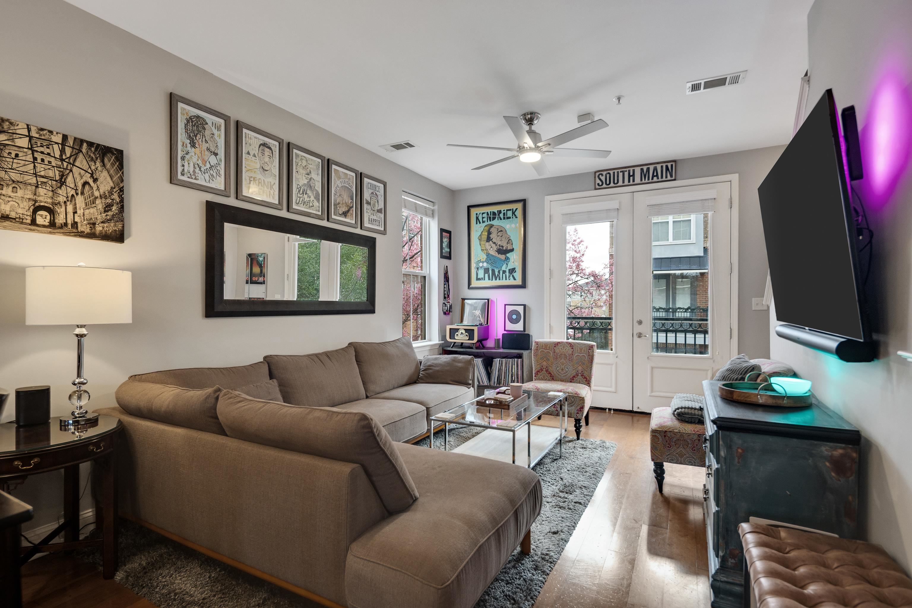 79 Shoemaker Court, Unit 108 Memphis, TN 38103 - Photo 13 of 33 a living room with furniture a flat screen tv and a window