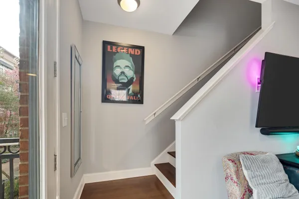 a view of a hallway with wooden floor and closet