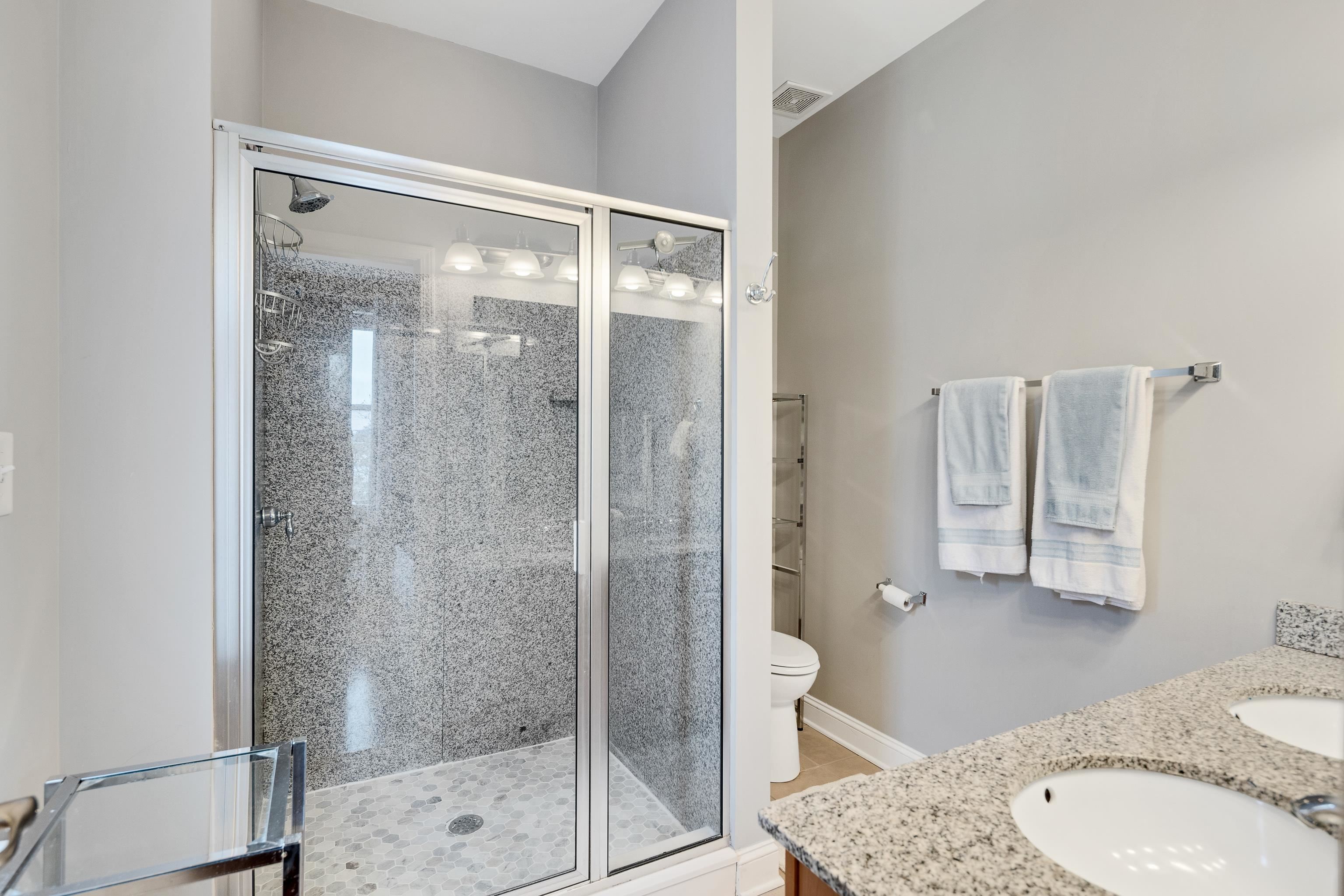 79 Shoemaker Court, Unit 108 Memphis, TN 38103 - Photo 22 of 33 a bathroom with a granite countertop shower and a sink