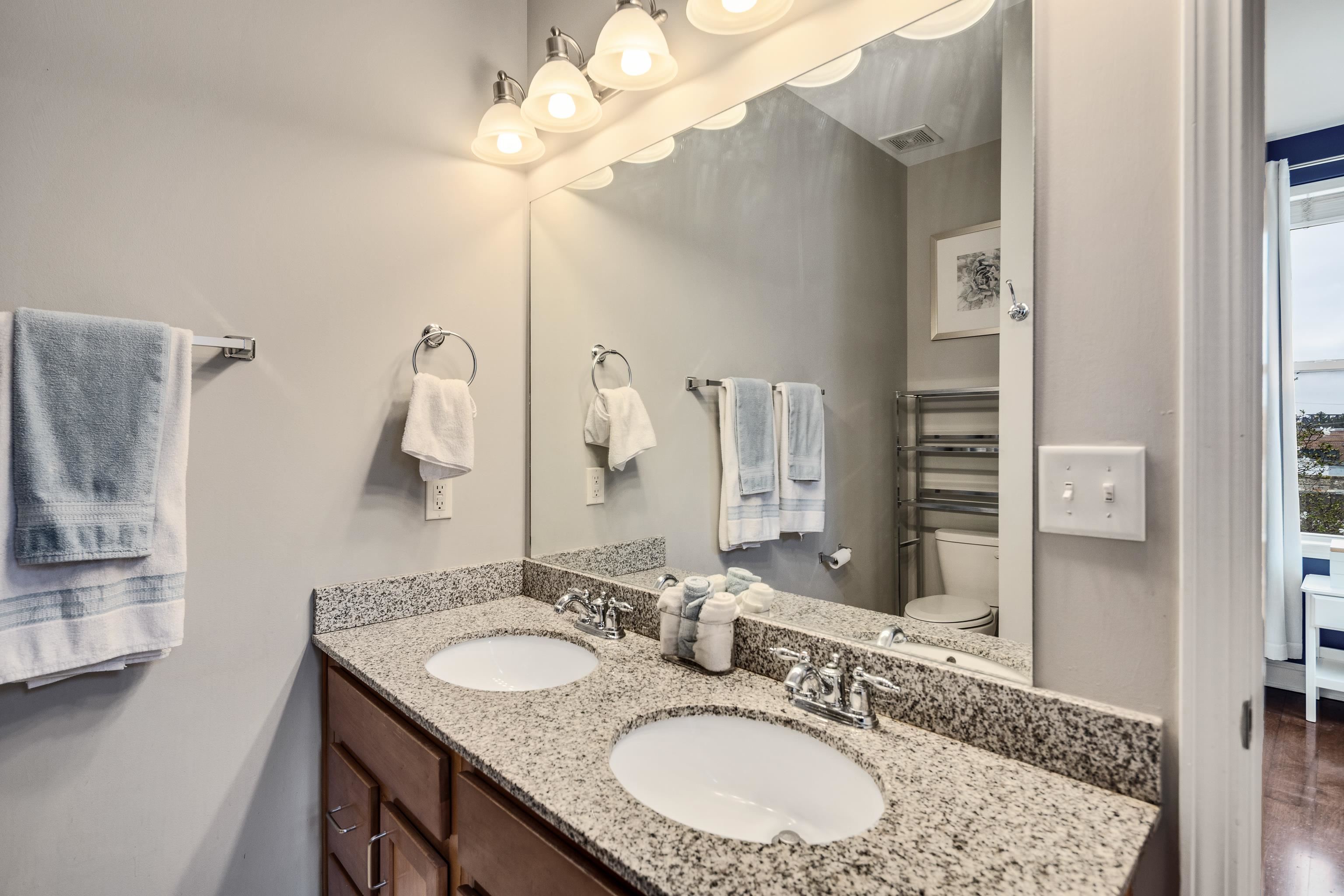 79 Shoemaker Court, Unit 108 Memphis, TN 38103 - Photo 23 of 33 a bathroom with a granite countertop double vanity sink and a mirror